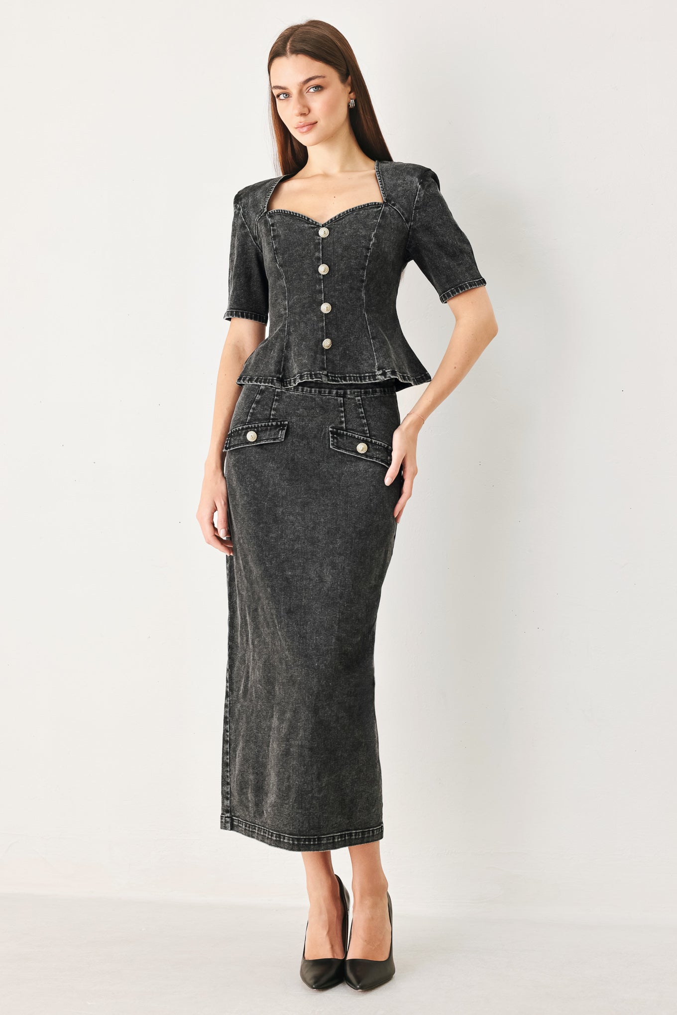 Woman wearing a black denim top featuring sweetheart neckline, short sleeve, front button down and peplum | FREEMARKET