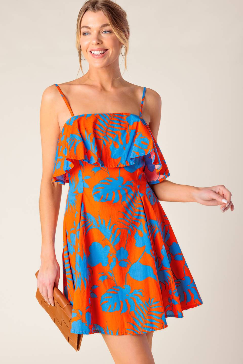A printed woven mini dress featuring straight neckline, straps, flounce, full skirt and back zipper closure