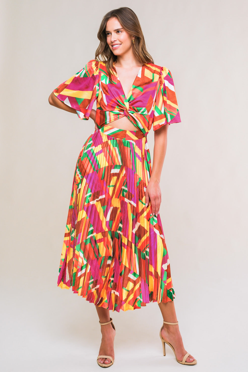 A printed woven midi dress featuring V  neckline with front twist and cut out detail, short sleeve, pleated skirt and elasticized back waist
Details:
Self : 100% Polyester
Size & Fit
- Model is 5`8" And Wearing Size Small
- Measurements Taken From Size Small
- Approx. Length: 52"