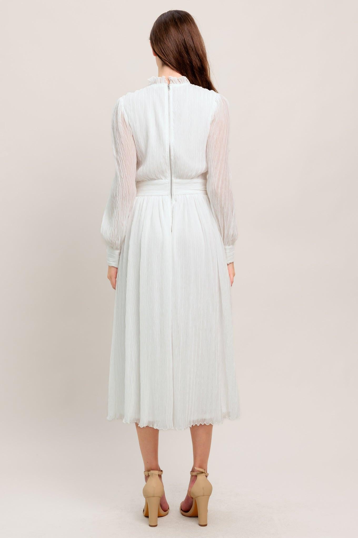 A textured woven midi dress featuring high neckline with ruffled edge, long sleeve with cuff, full skirt and back zipper closure
Details:
Self : 100% Polyester
Lining: 100% Polyester
Size & Fit
- Model is 5`7" And Wearing Size Small
- Measurements Taken From Size Small
- Approx. Length: 48"