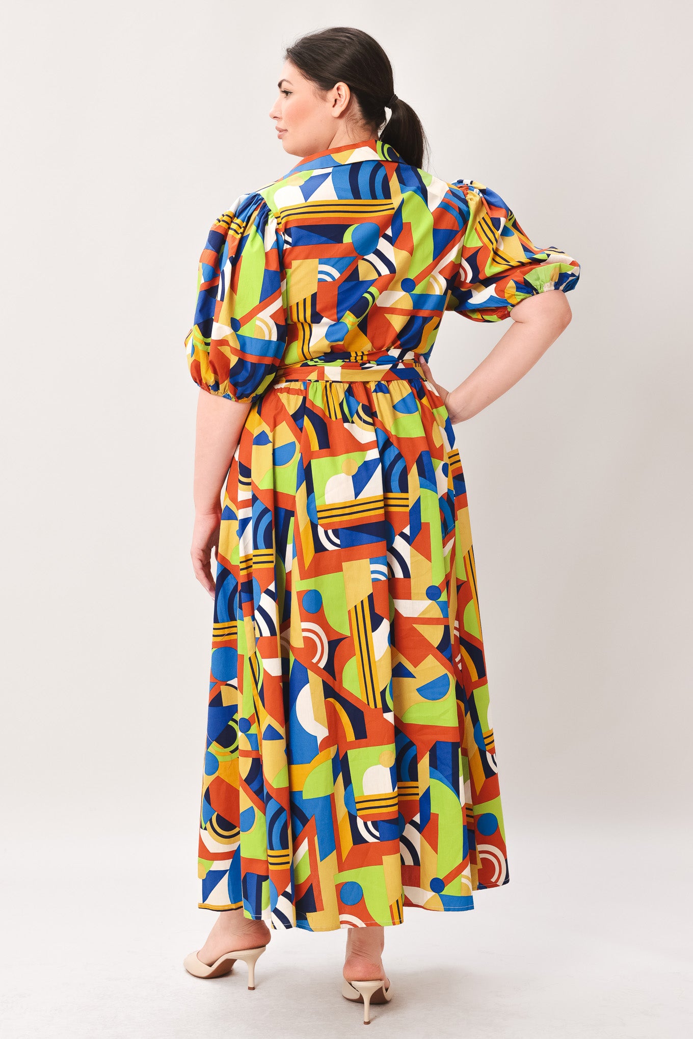Woman wearing a colorful patterned dress on a white background | Curve | Flying Tomato