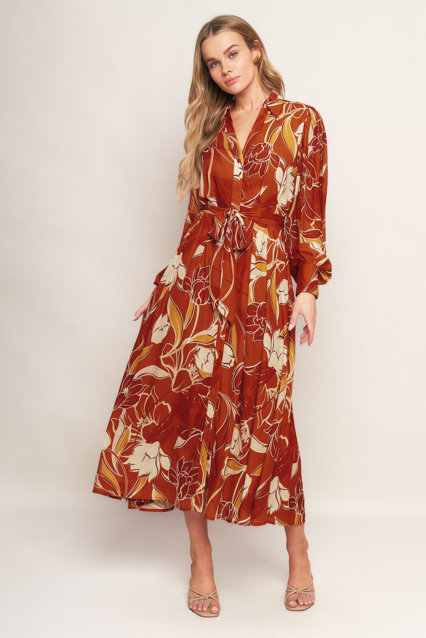 A printed woven midi dress featuring shirt collar, V neckline, long sleeves, button down, self sash tie and full skirt