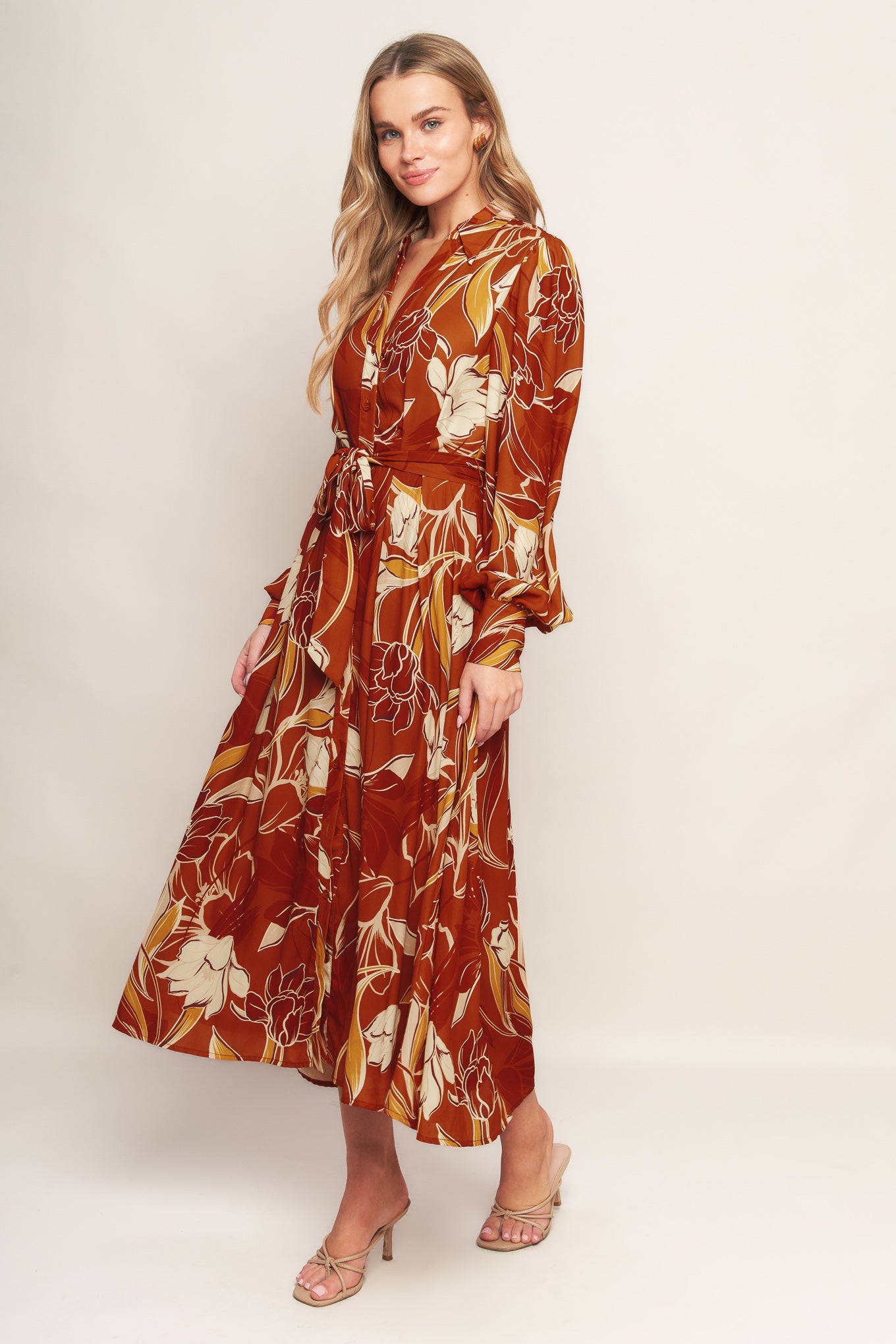 A printed woven midi dress featuring shirt collar, V neckline, long sleeves, button down, self sash tie and full skirt