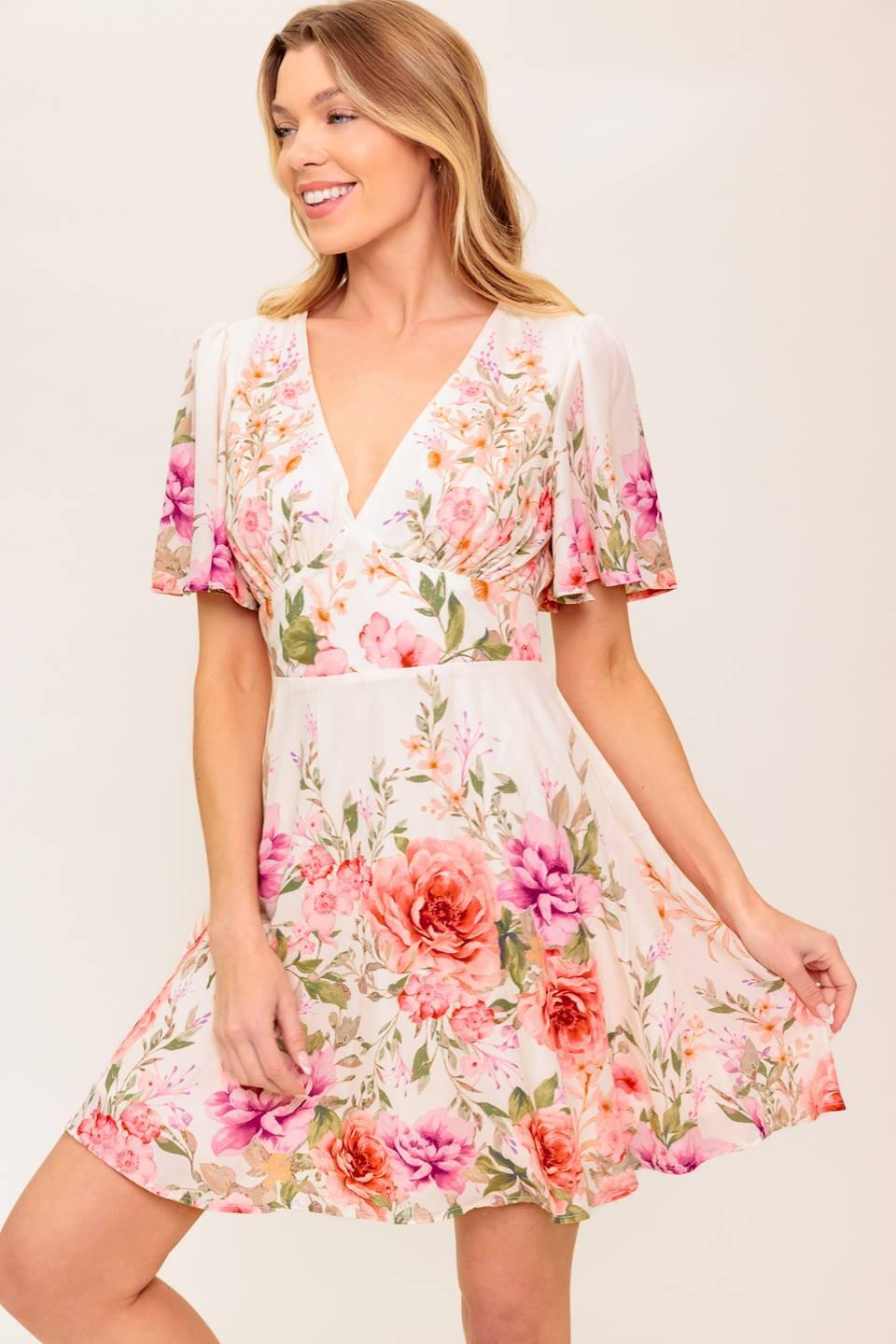 A printed woven mini dress featuring V neckline, long sleeve, waist yoke, ruffled hemline and back zipper closure