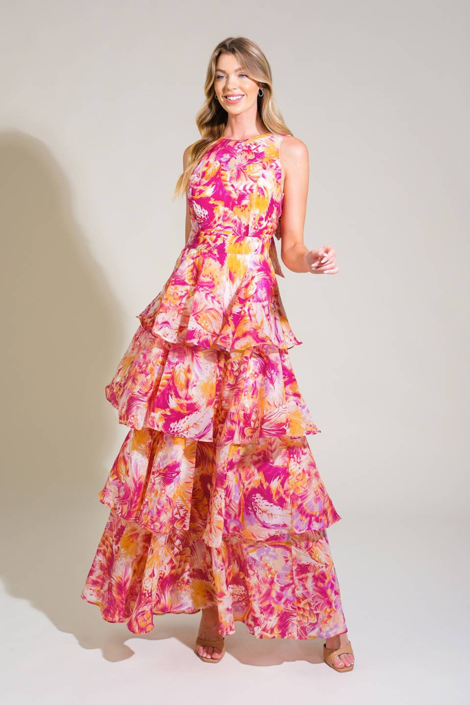 A printed woven maxi dress featuring round neckline, sleeveless, layered skirt, open back with tie and zipper closure
Details:
Self : 100% Polyester
Lining : 100% Polyester
     
Size & Fit
- Model is 5`8" And Wearing Size Small
- Measurements Taken From Size Small
- Approx. Length: 58"