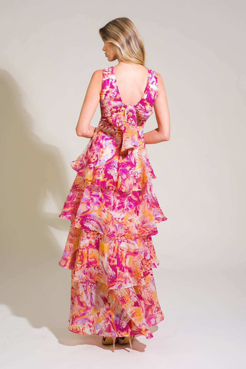 A printed woven maxi dress featuring round neckline, sleeveless, layered skirt, open back with tie and zipper closure
Details:
Self : 100% Polyester
Lining : 100% Polyester
     
Size & Fit
- Model is 5`8" And Wearing Size Small
- Measurements Taken From Size Small
- Approx. Length: 58"