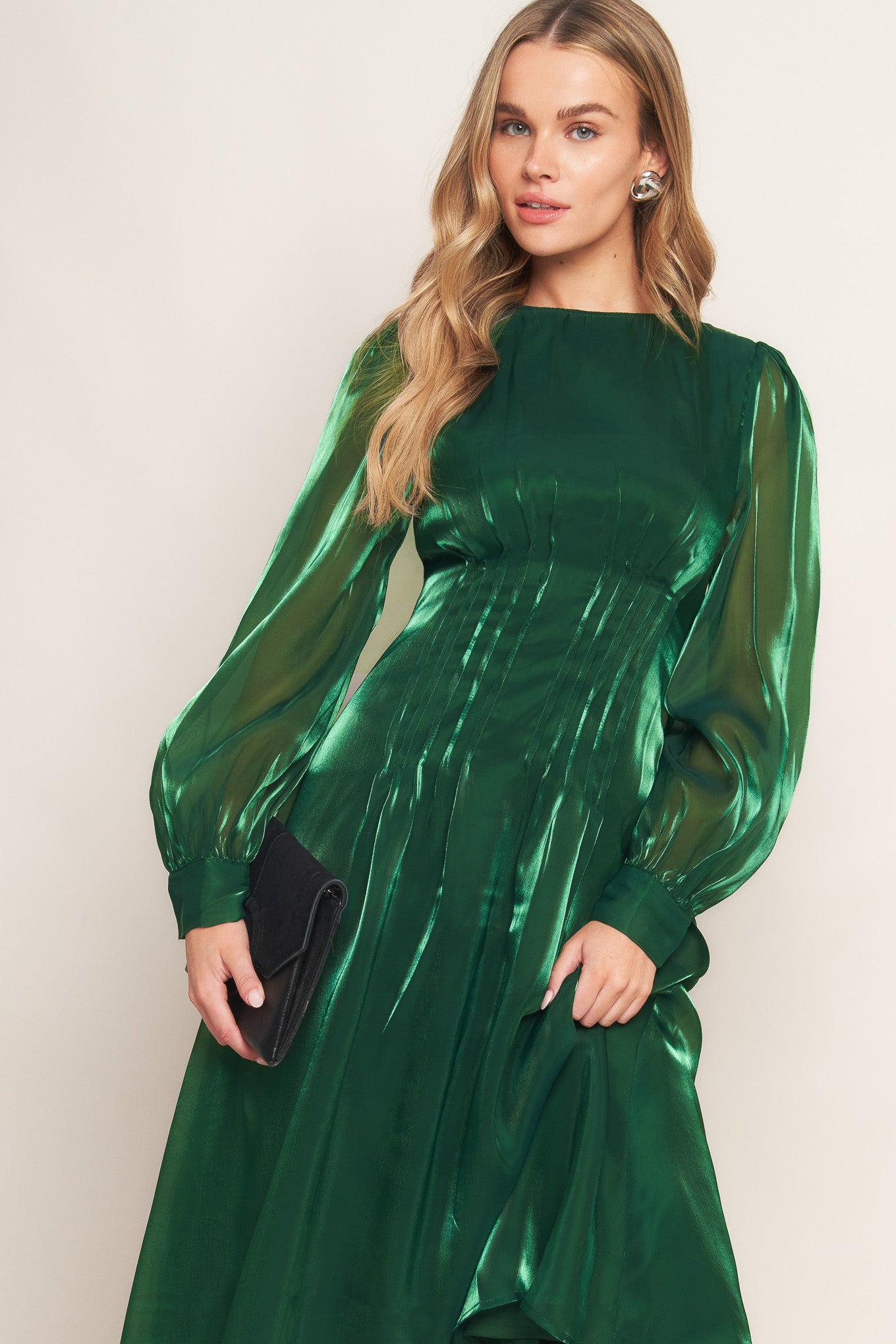 A solid woven midi dress featuring round neckline, long sleeve, cinching detail at waist and back zipper closure