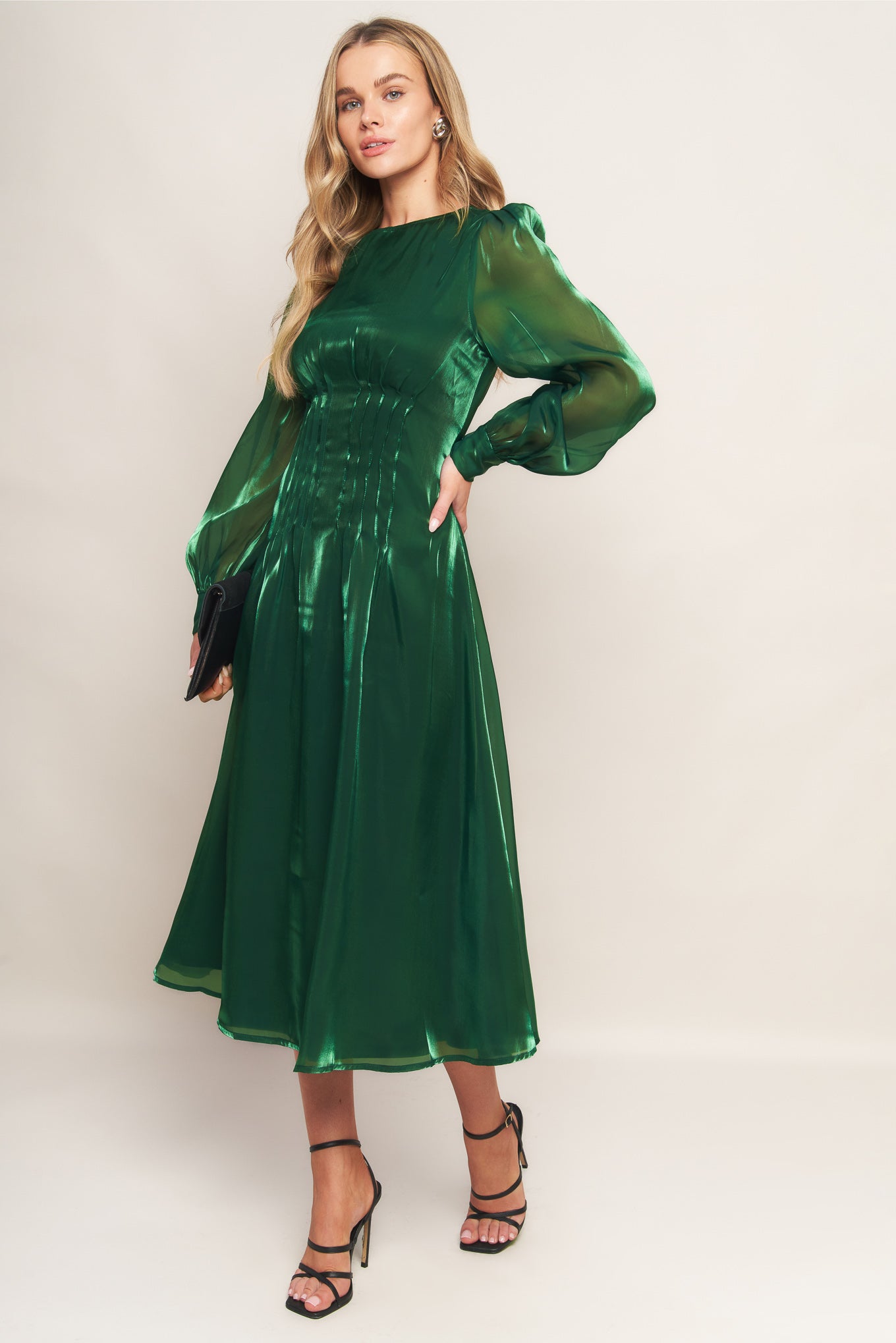 A solid woven midi dress featuring round neckline, long sleeve, cinching detail at waist and back zipper closure
