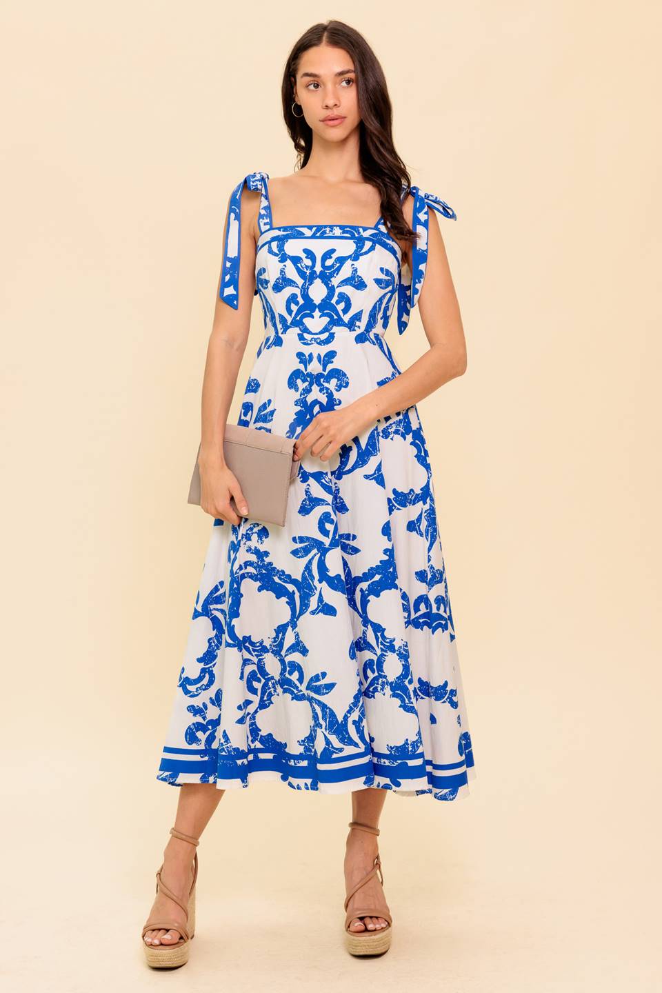 A printed woven midi dress featuring straight neckline, shoulder strap, circle skirt and back zipper closure