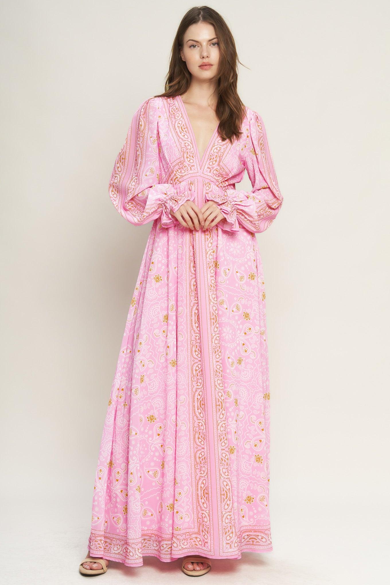 A printed woven maxi dress featuring a V neckline, long sleeve with ruffled cuff, and elasticized waist