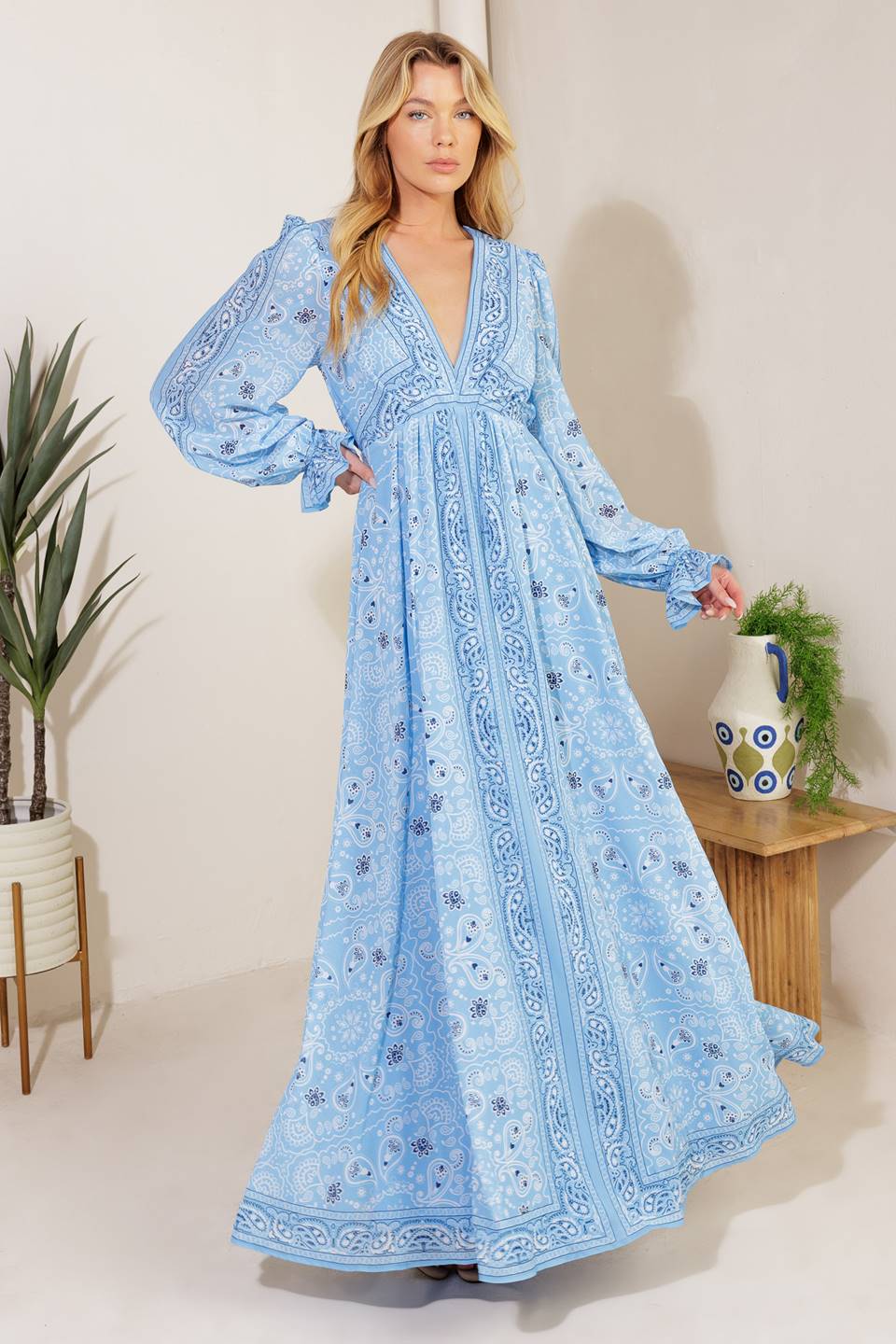 A printed woven maxi dress featuring a V neckline, long sleeve with ruffled cuff, and elasticized waist