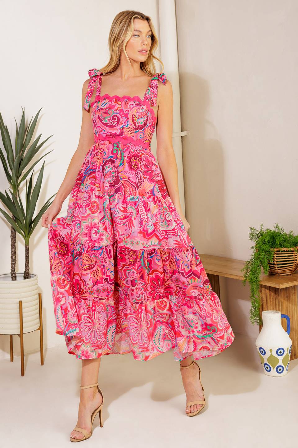 A printed woven midi dress featuring straight neckline, shoulder ties, ric rac ribbon trim, tiered skirt and smocked back bodic