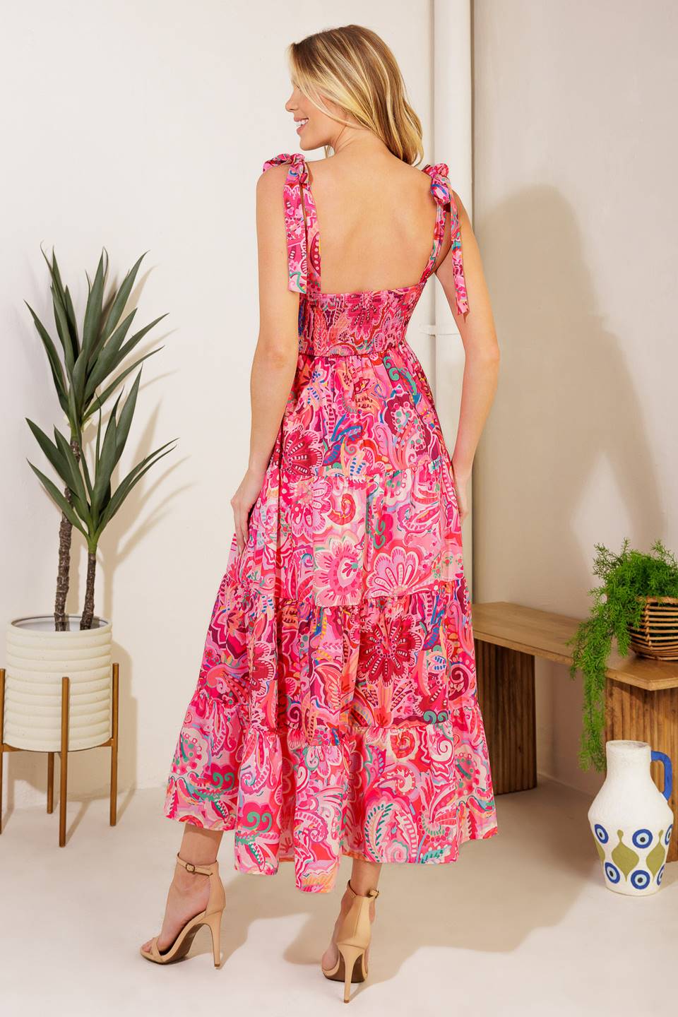 A printed woven midi dress featuring straight neckline, shoulder ties, ric rac ribbon trim, tiered skirt and smocked back bodic