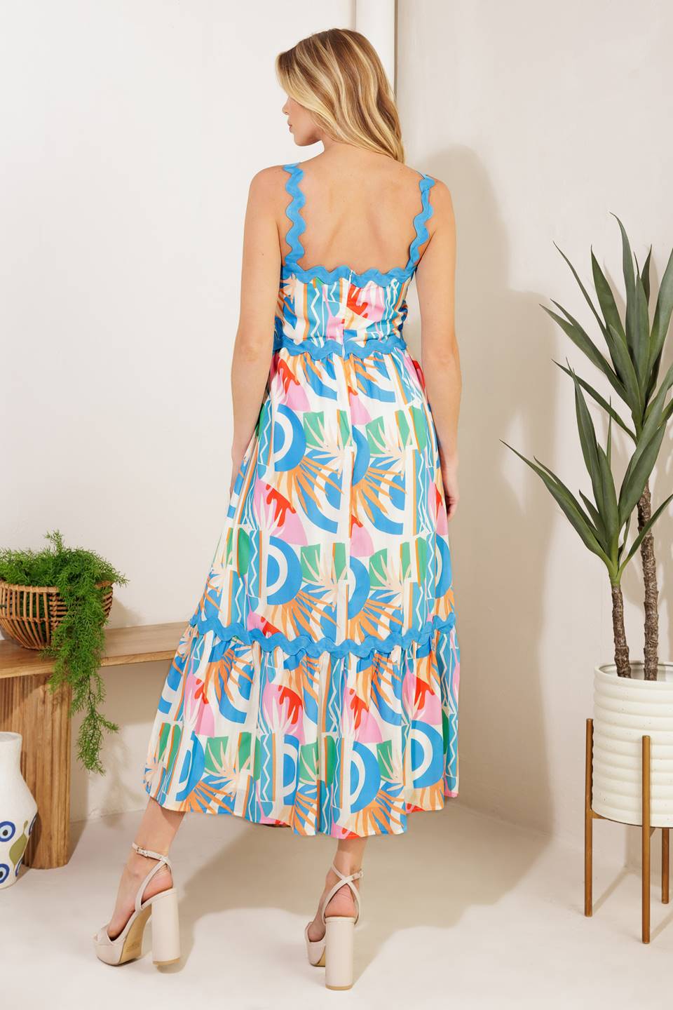 A printed woven midi dress featuring a straight neckline, ric rac ribbon strap/trim, ruffled hemline ,and back zipper closure
Details:
Self: 100% Polyester 
Lining: 100% Polyester
Size & Fit
- Model is 5`10" And Wearing Size Small
- Measurements Taken From Size Small
- Approx. Length: 52"