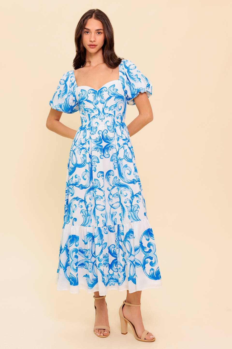 A printed woven midi dress featuring sweetheart neckline, short puff sleeve, ruffled hemline and smocked back bodice