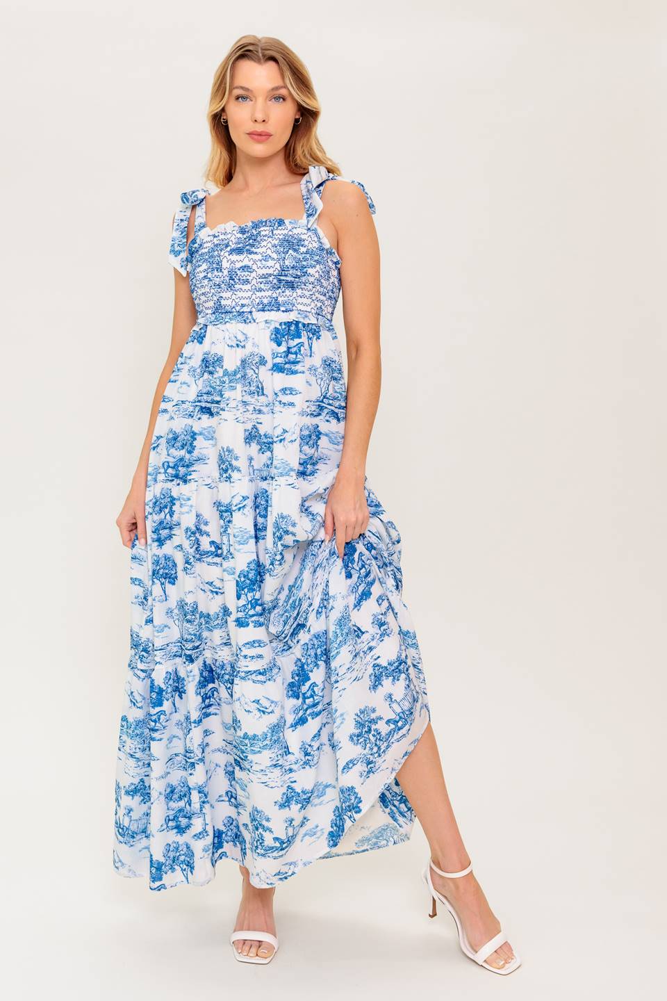 A printed woven midi dress featuring sweetheart neckline, shoulder ties, smocked bodice and tiered skirt