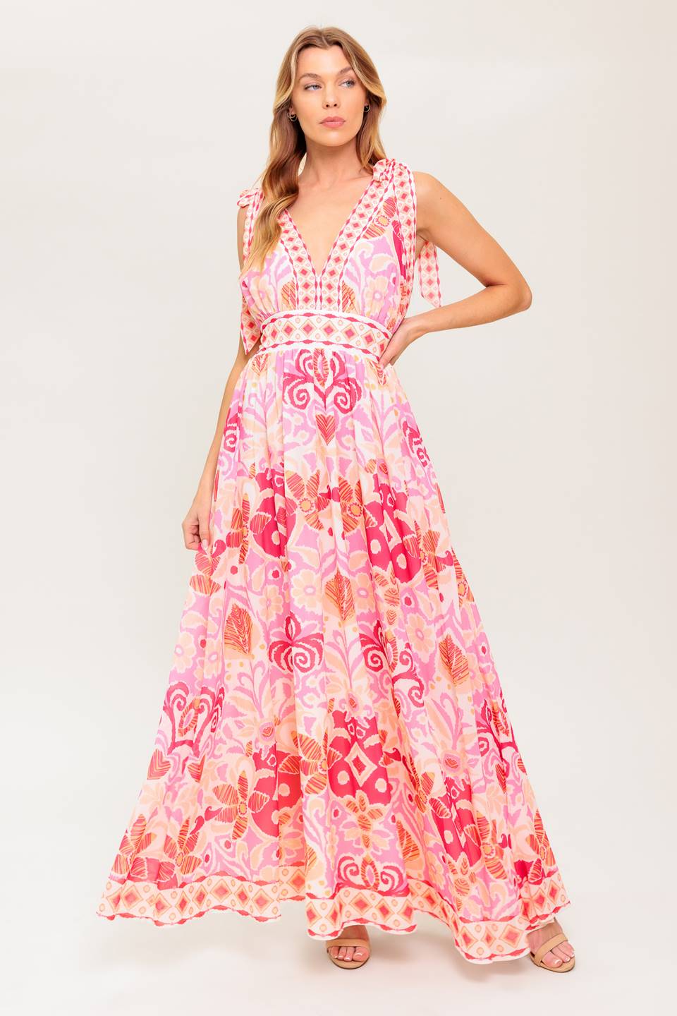 A printed woven maxi dress featuring front/back V neckline, shoulder ties and smocked back waistband