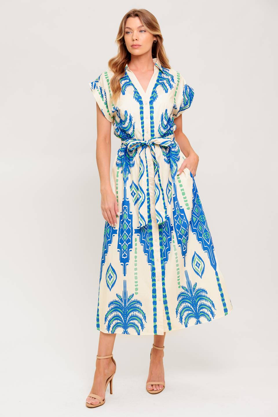 A printed woven midi dress featuring collar, V neckline, short sleeve, button down and self sash tie.