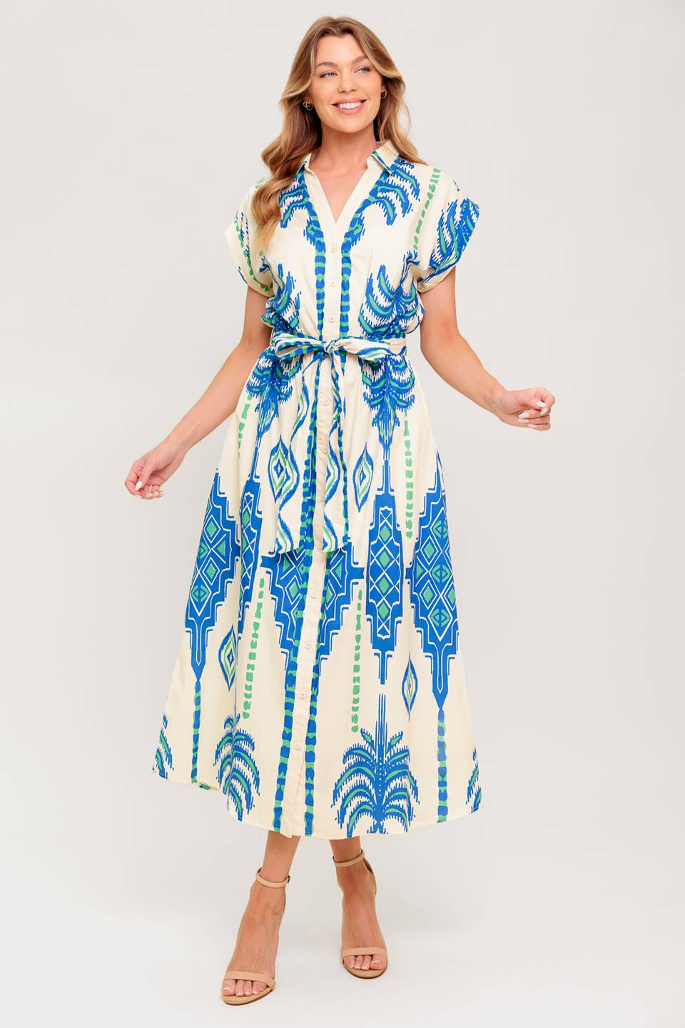 A printed woven midi dress featuring collar, V neckline, short sleeve, button down and self sash tie.