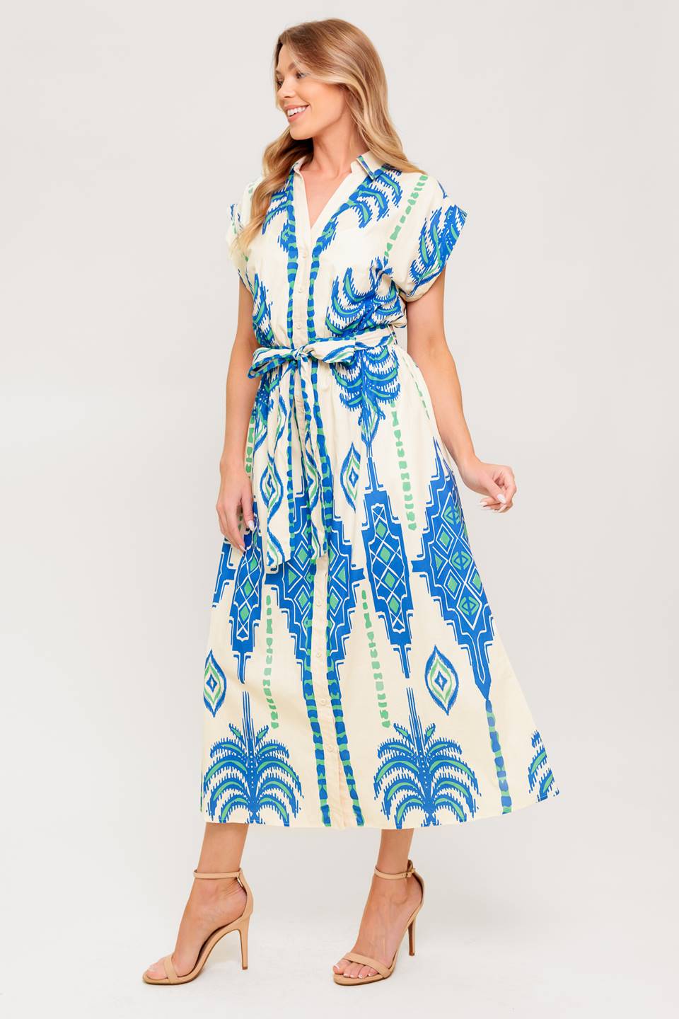A printed woven midi dress featuring collar, V neckline, short sleeve, button down and self sash tie.