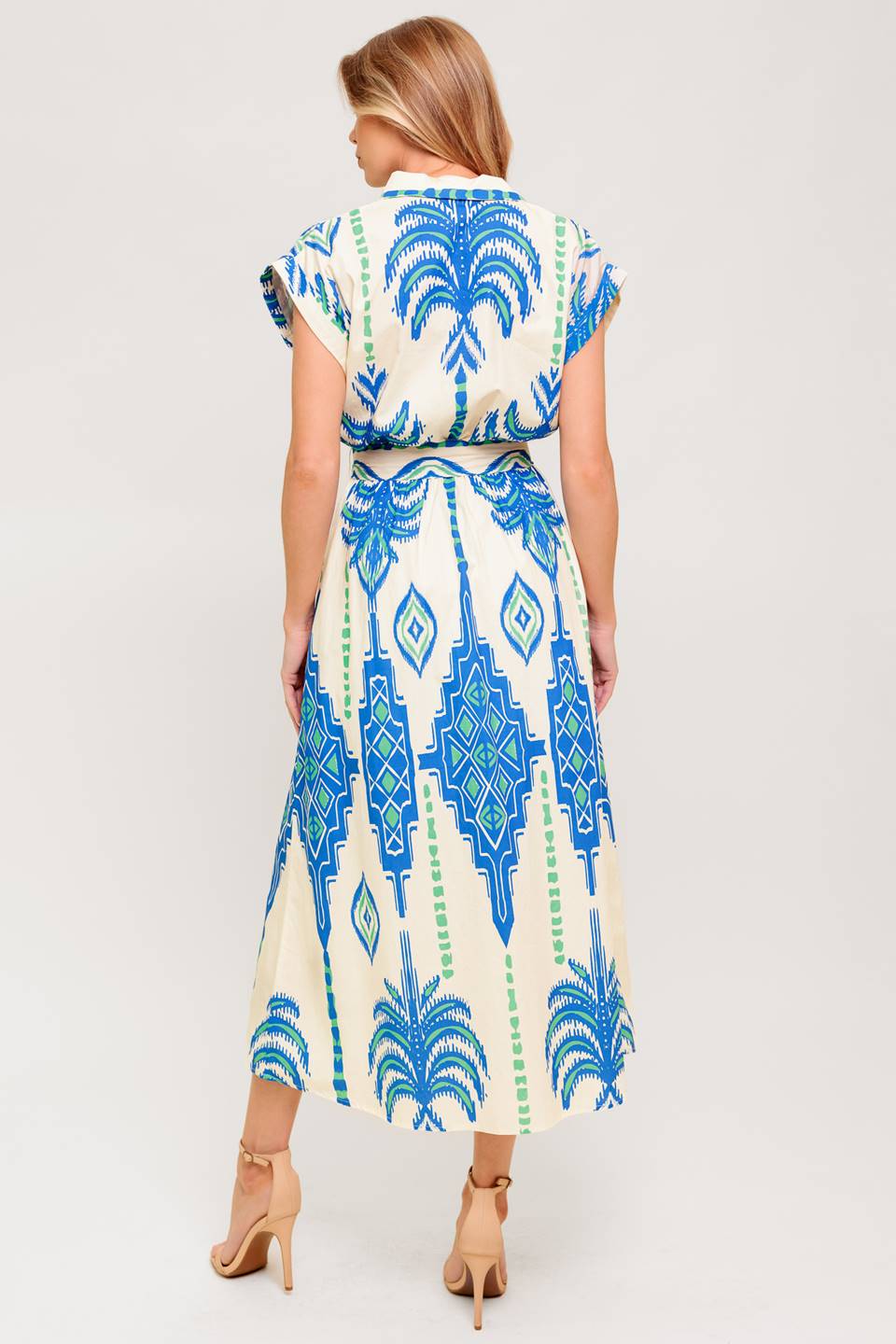 A printed woven midi dress featuring collar, V neckline, short sleeve, button down and self sash tie.