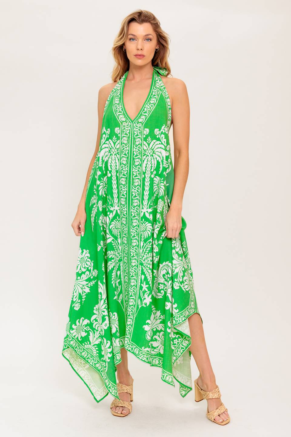 A printed woven midi dress featuring halter neckline with back neck tie, hanky hemline and bare back