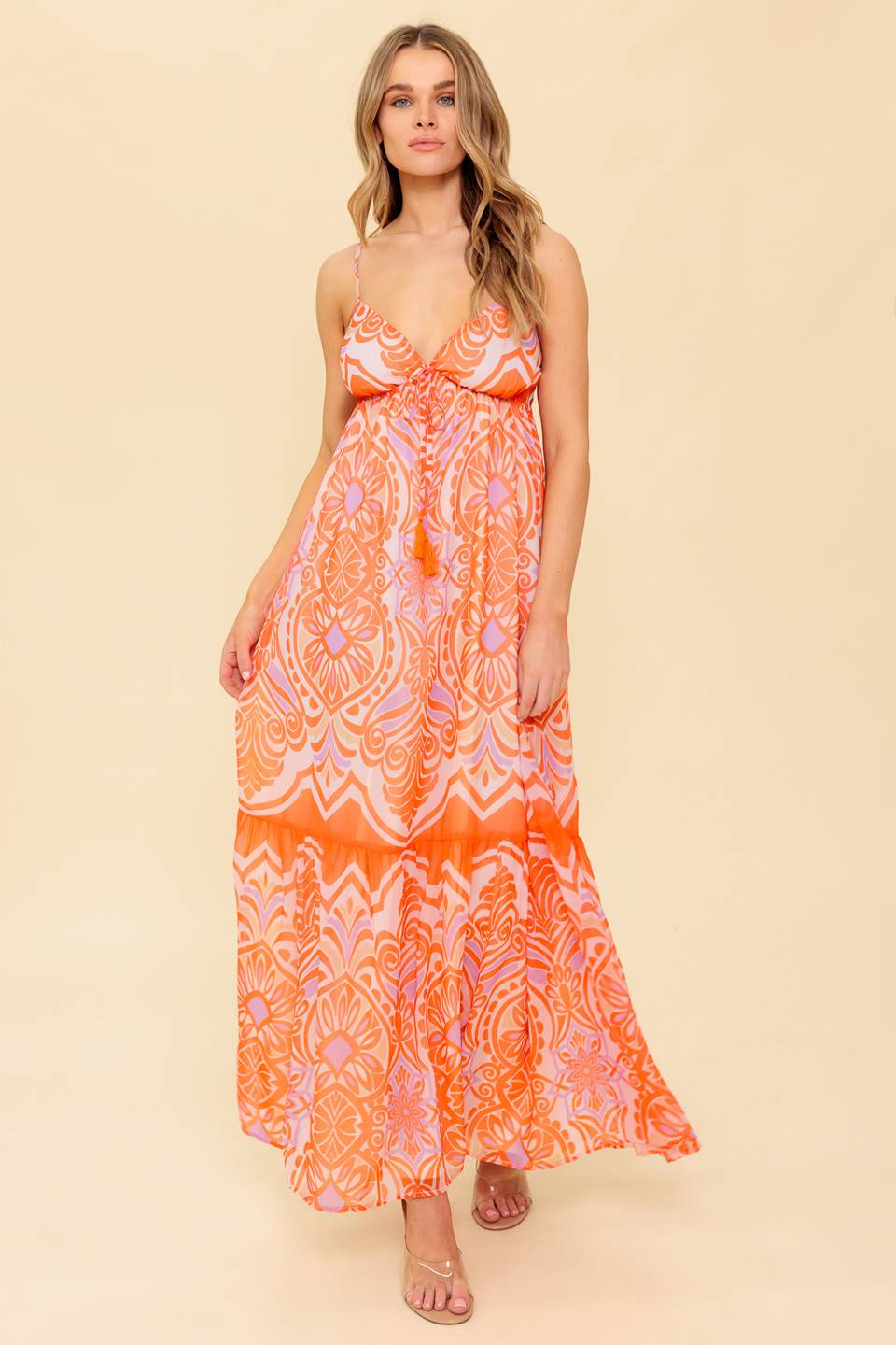 A printed woven maxi dress featuring cami top, elasticized empire with tie and ruffled hemline