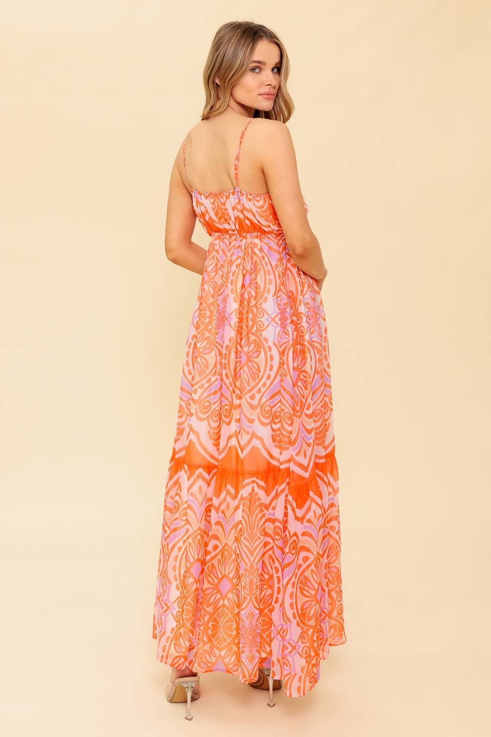 A printed woven maxi dress featuring cami top, elasticized empire with tie and ruffled hemline