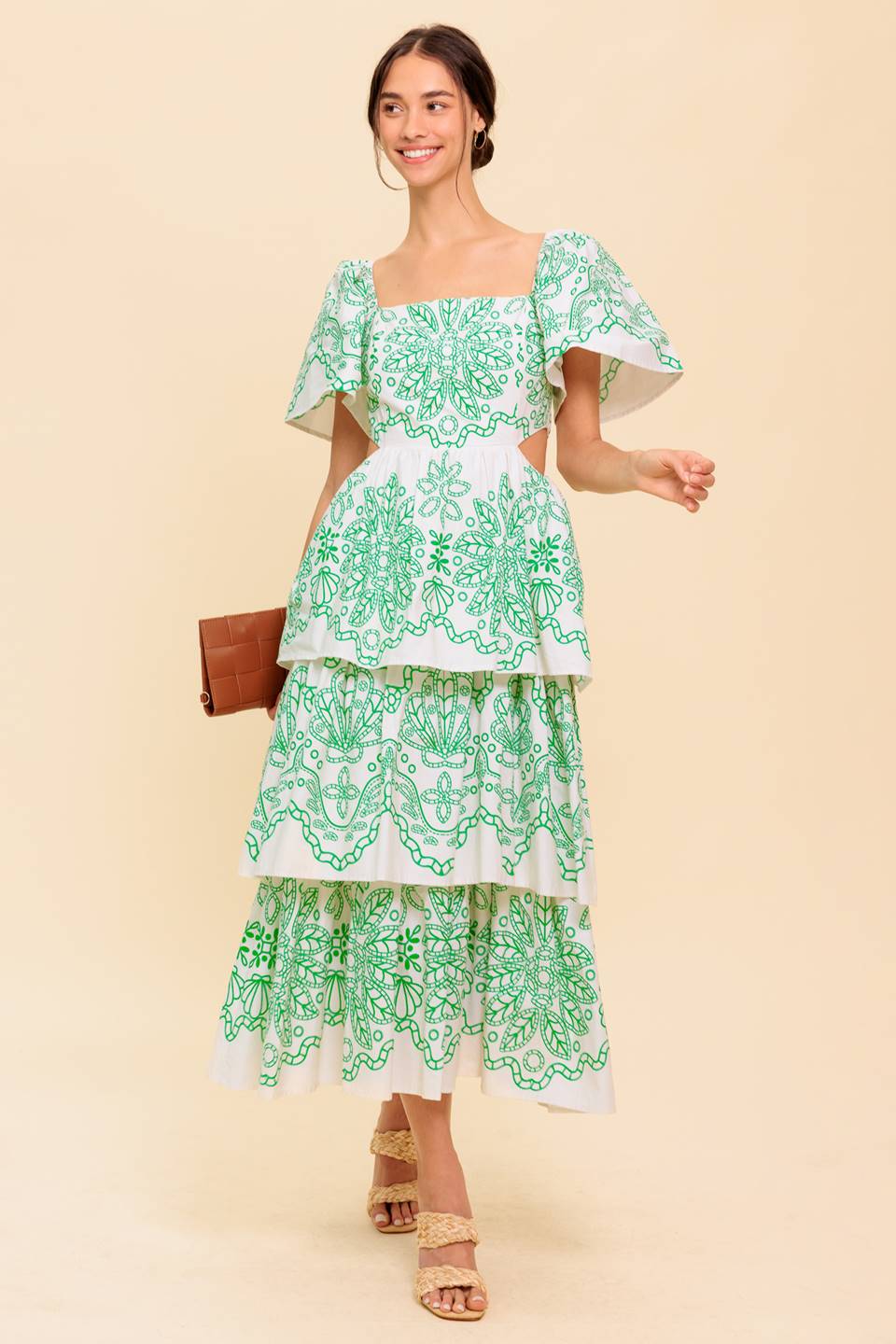 A printed woven midi dress featuring square neckline, short sleeve, side cut out, layered skirt and back zipper closure