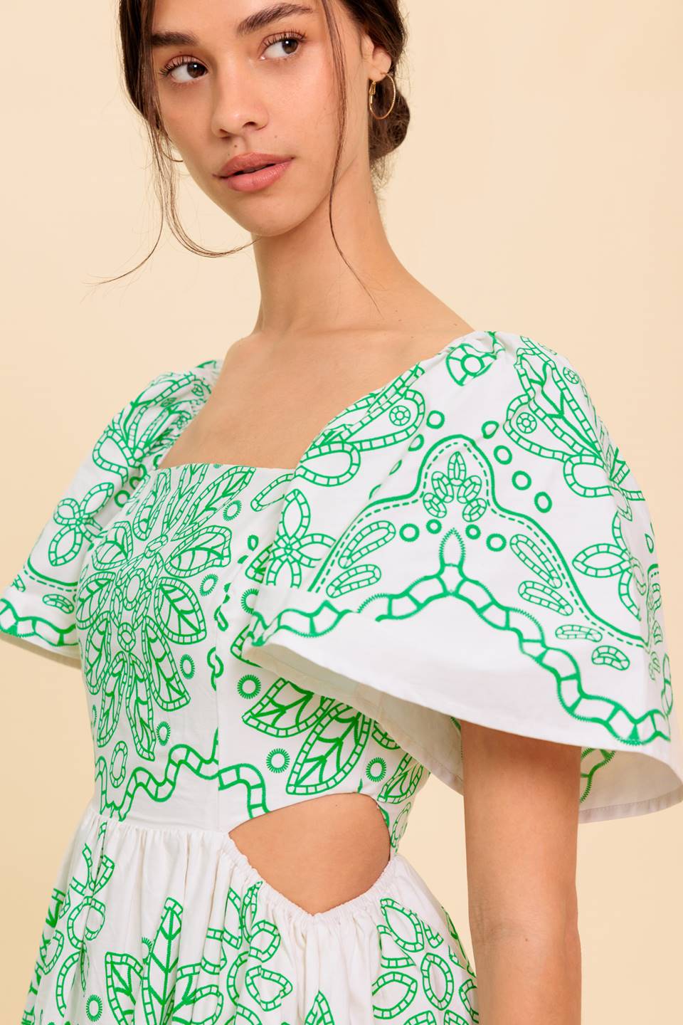 A printed woven midi dress featuring square neckline, short sleeve, side cut out, layered skirt and back zipper closure