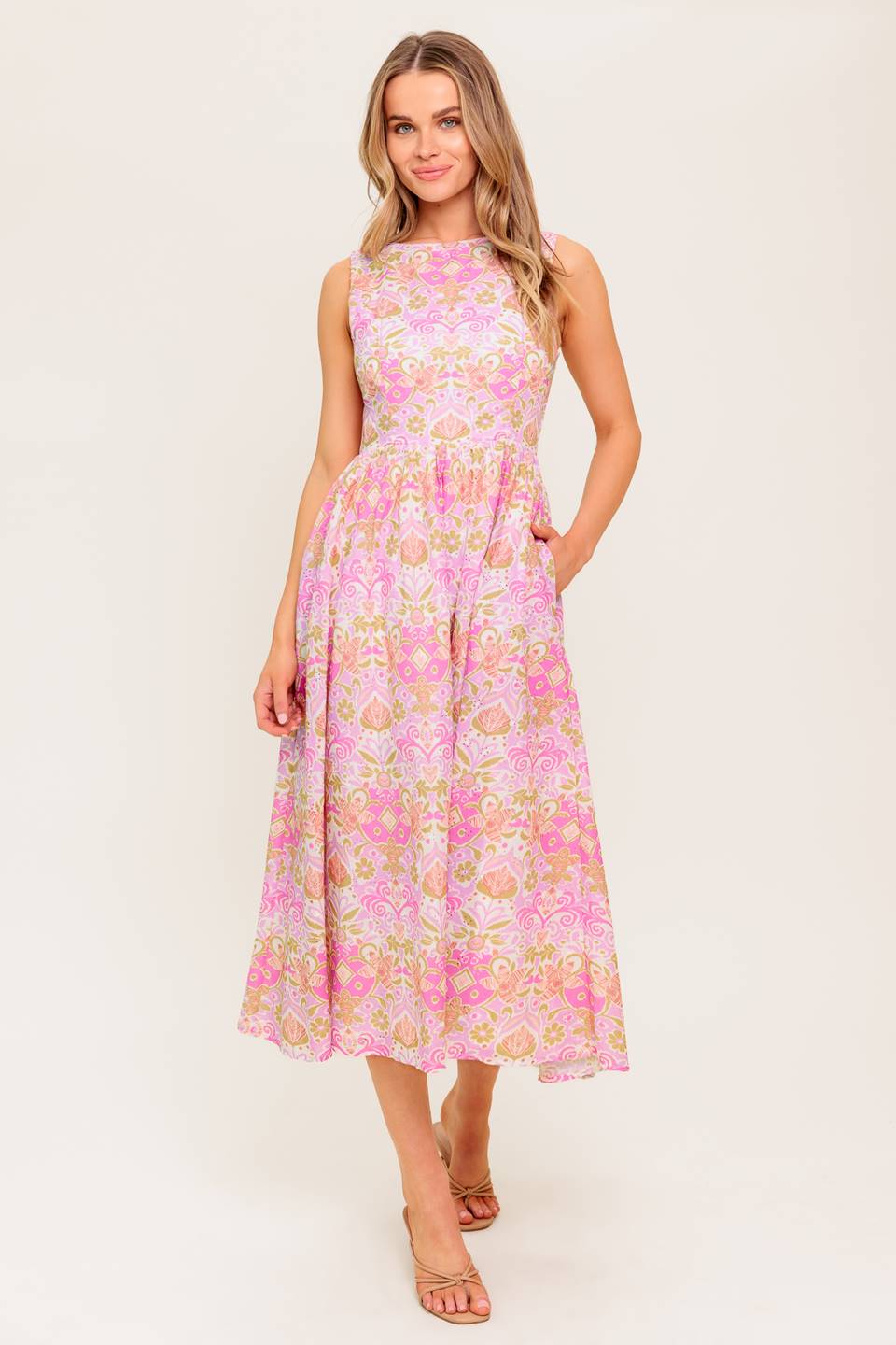 A printed woven midi dress featuring wide neckline, sleeveless, full skirt and back zipper closure.