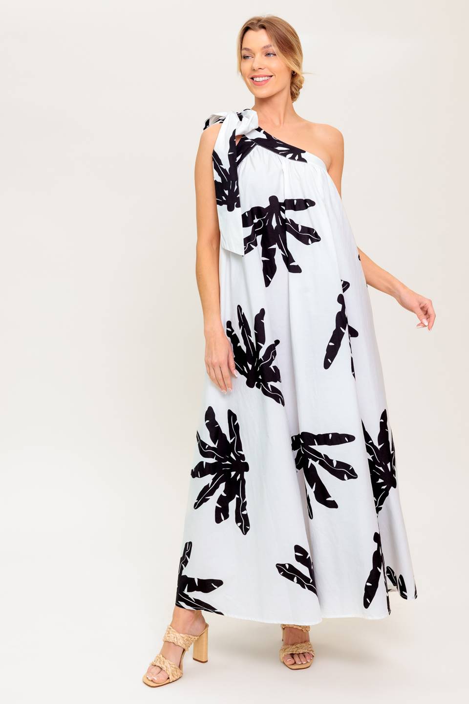 A white and black printed woven maxi dress featuring one shoulder neckline with tie and relaxed body