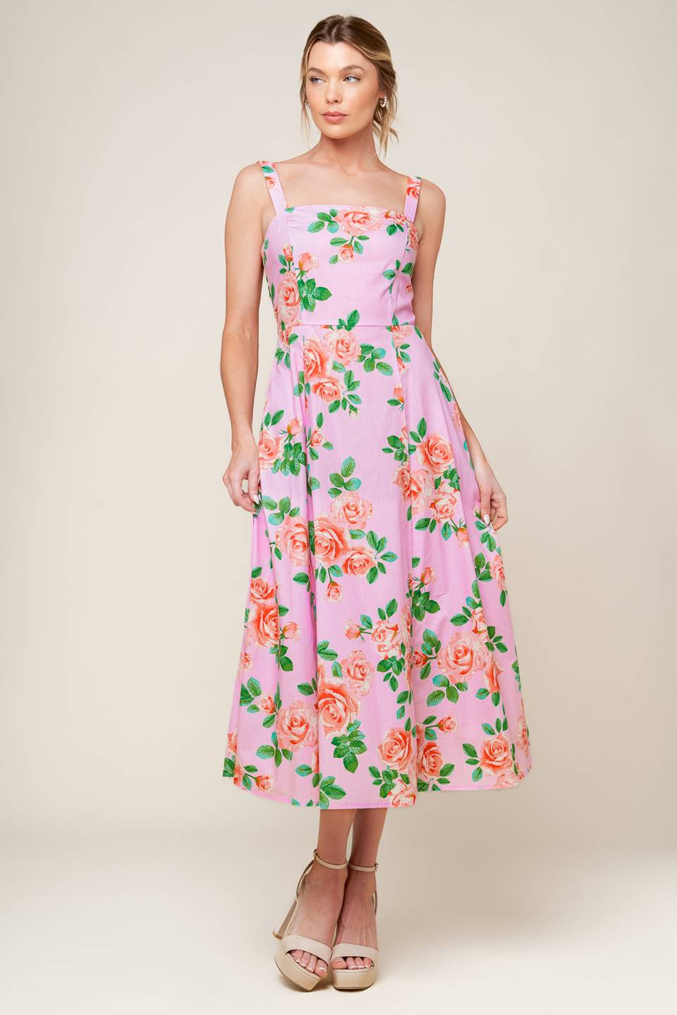 A pink floral printed woven midi dress featuring straight neckline, straps, circle skirt and back zipper closure.