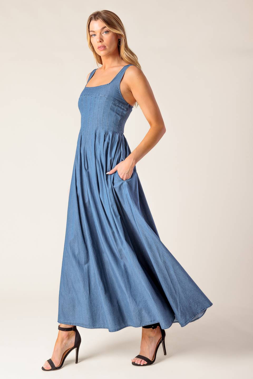 A washed lightweight denim midi dress featuring square neckline, sleeveless, pintuck bodice, full skirt and smocked back bodice