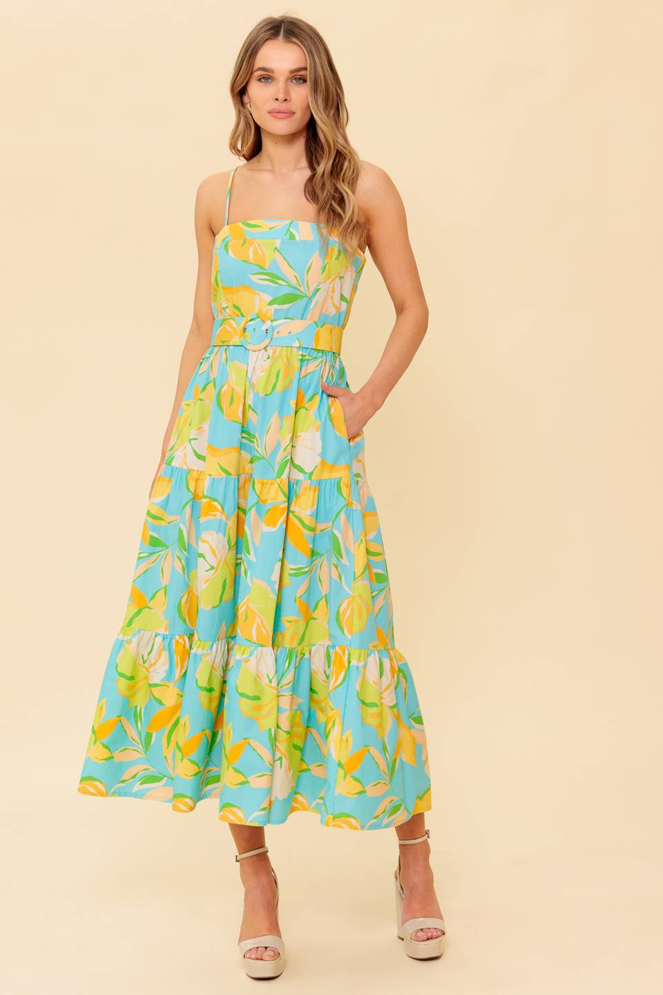 A teal and yellow printed woven midi dress featuring straight neckline, straps, self belt, tiered skirt and back zipper closure