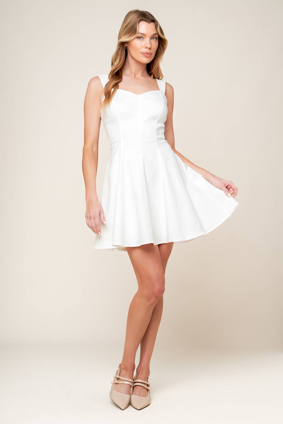 A solid woven mini dress featuring sweetheart neckline, sleeveless, circle skirt and back zipper closure