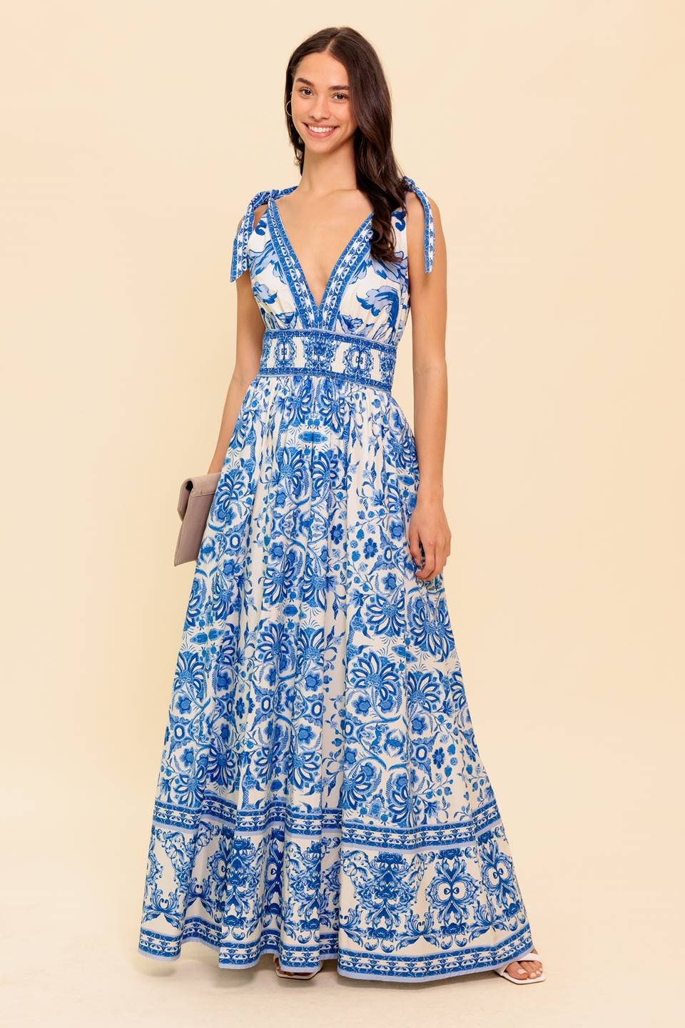 A printed woven maxi dress featuring front and back V neckline, shoulder ties, smocked waistband and full skirt