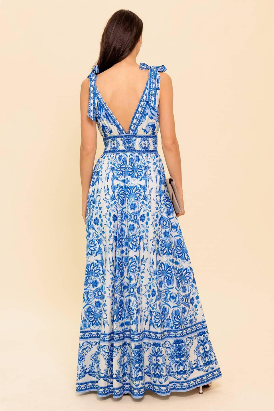 A printed woven maxi dress featuring front and back V neckline, shoulder ties, smocked waistband and full skirt