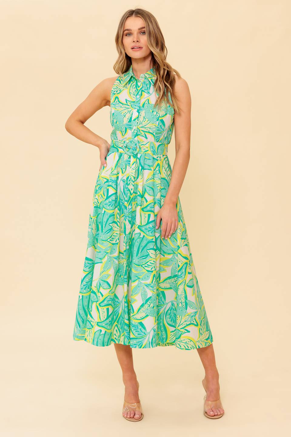 A printed woven midi dress featuring collar, sleeveless, button down and self belt
