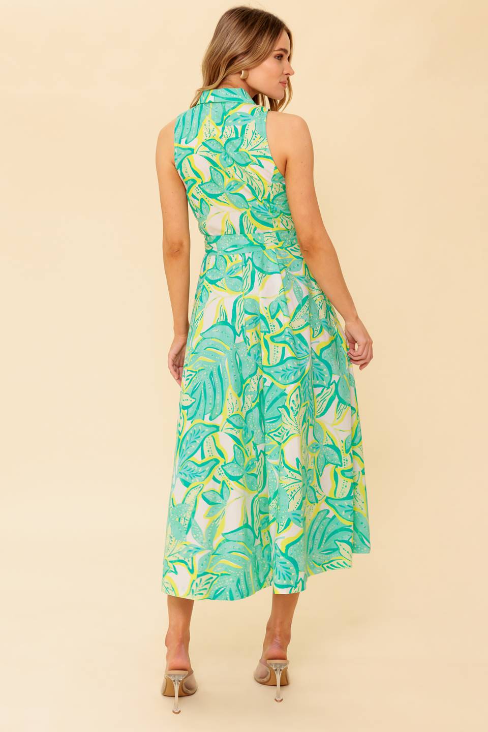 A printed woven midi dress featuring collar, sleeveless, button down and self belt