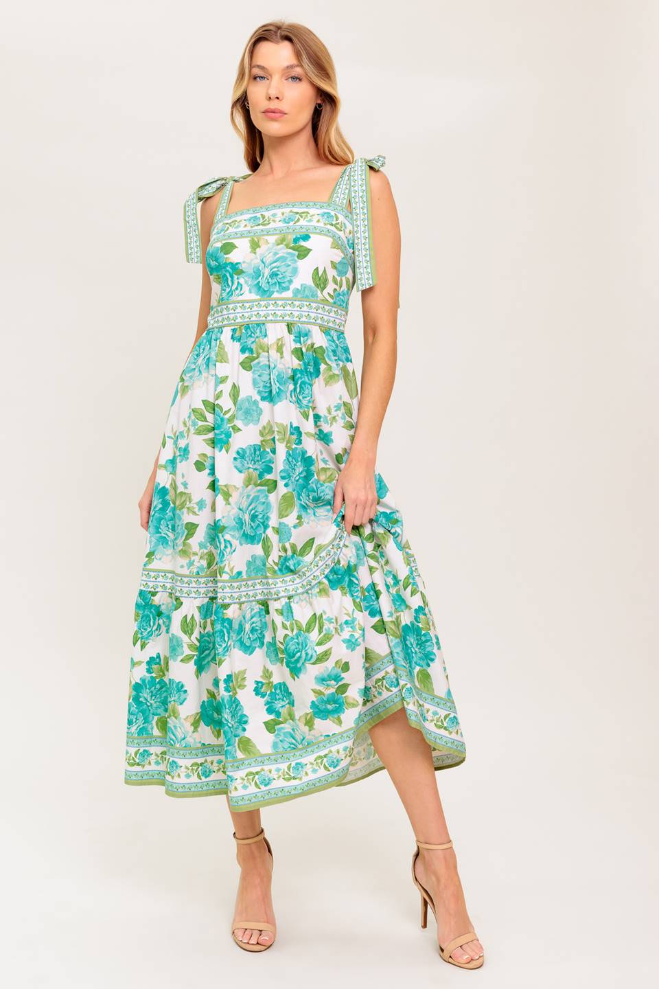 A printed woven midi dress featuring straight neckline, shoulder tie, ruffled hemline and back zipper closure