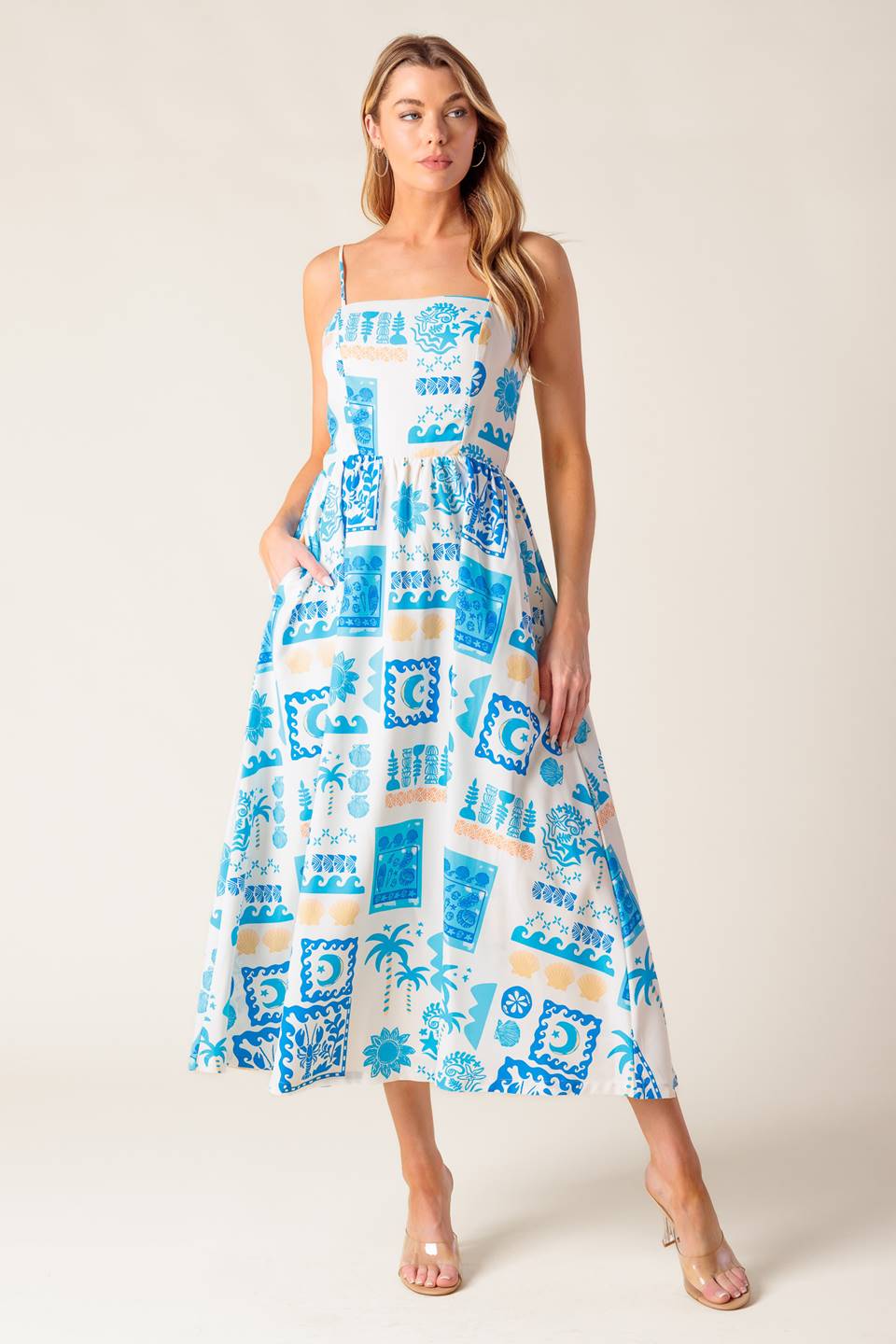 A printed woven midi dress featuring straight neckline, straps, full skirt and back zipper closure