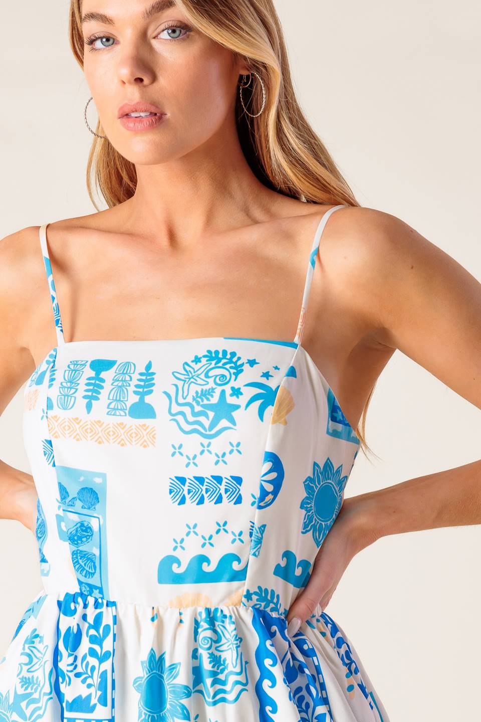 A printed woven midi dress featuring straight neckline, straps, full skirt and back zipper closure