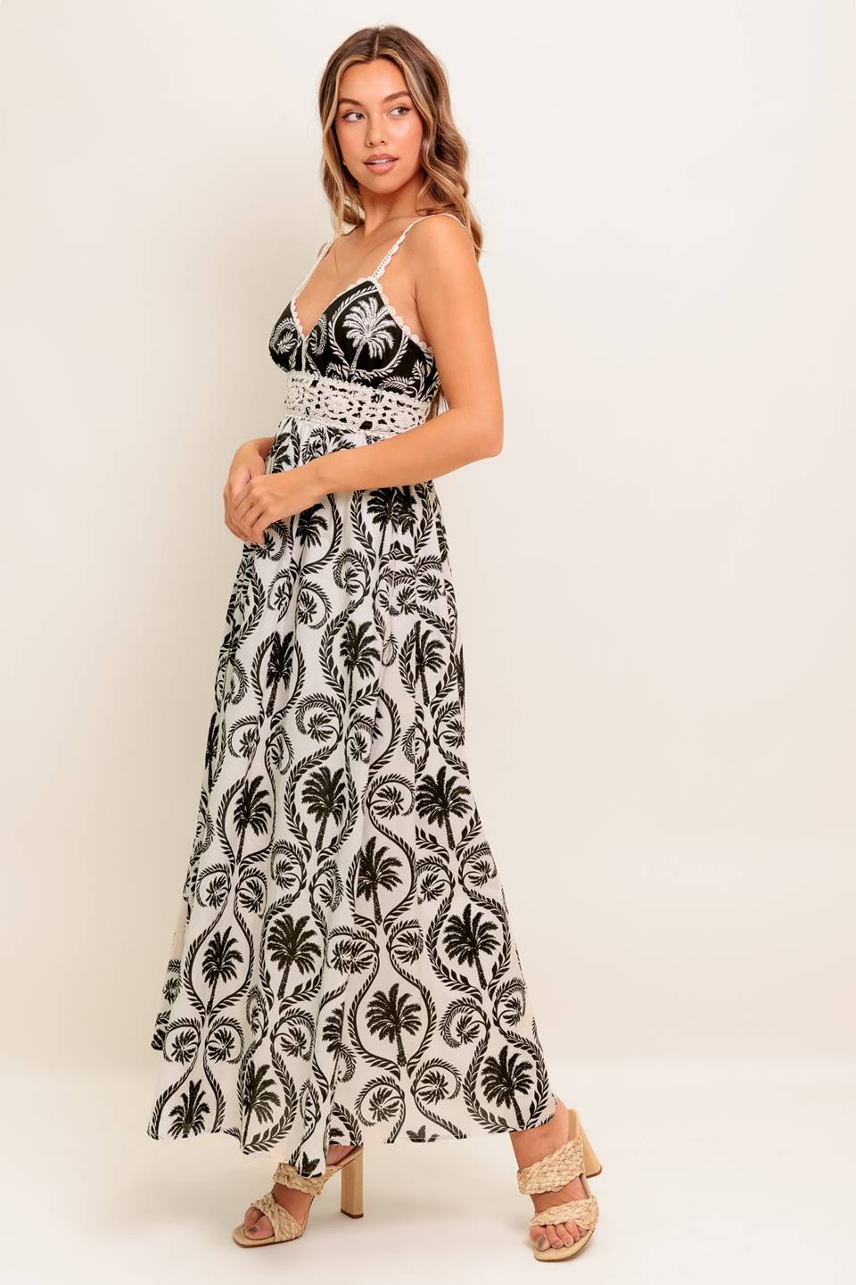 A printed woven maxi dress featuring cami top with crochet lace edge and waistband, full skirt and back zipper closure.