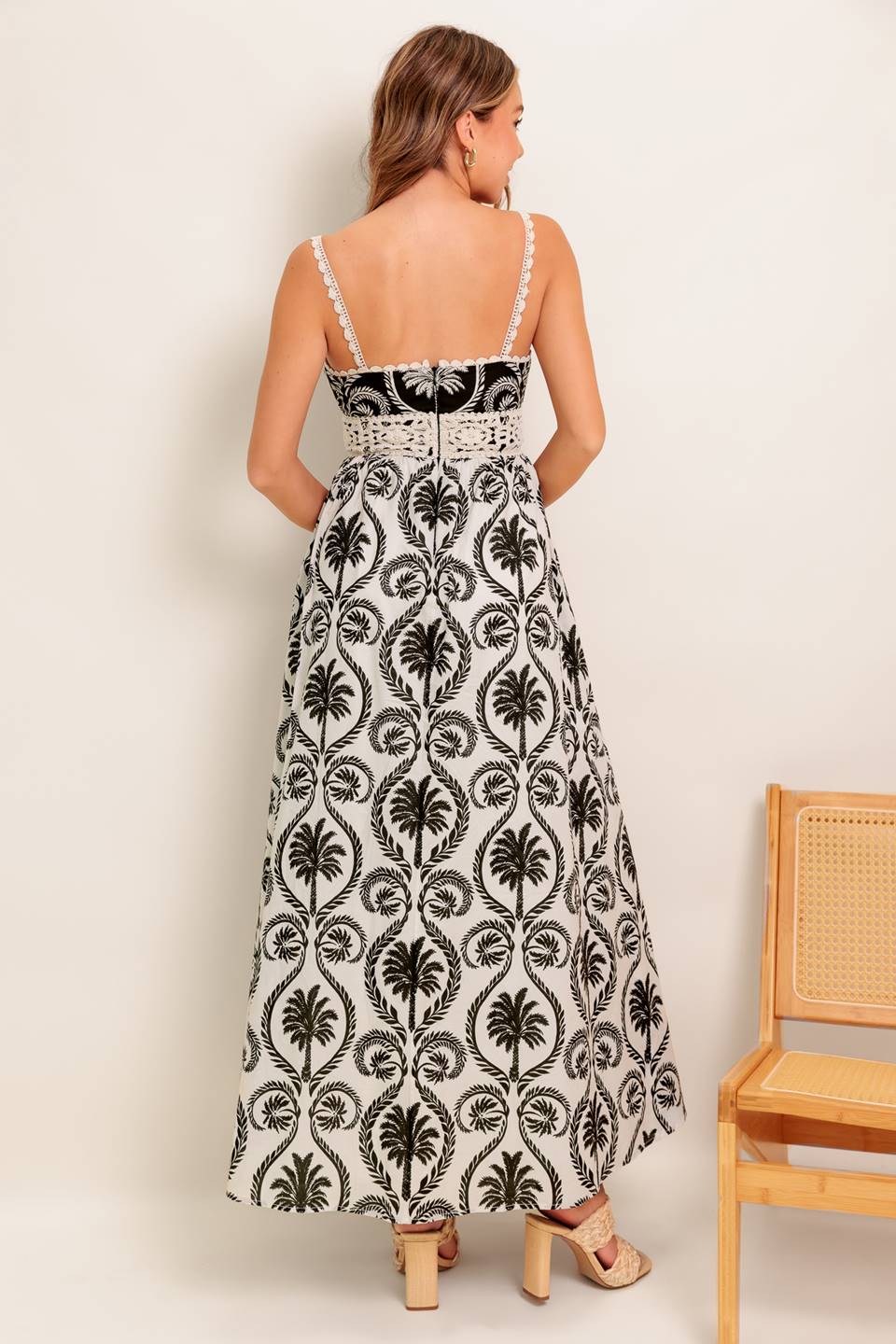 A printed woven maxi dress featuring cami top with crochet lace edge and waistband, full skirt and back zipper closure.