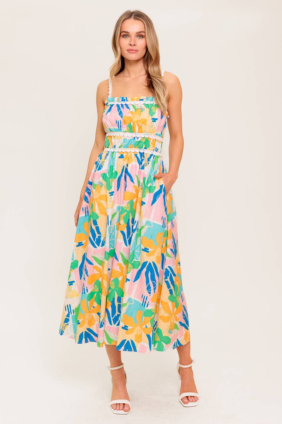 A printed woven midi dress featuring straight neckline, crochet lace strap and inset, shirred bust, full skirt and back zipper closure.