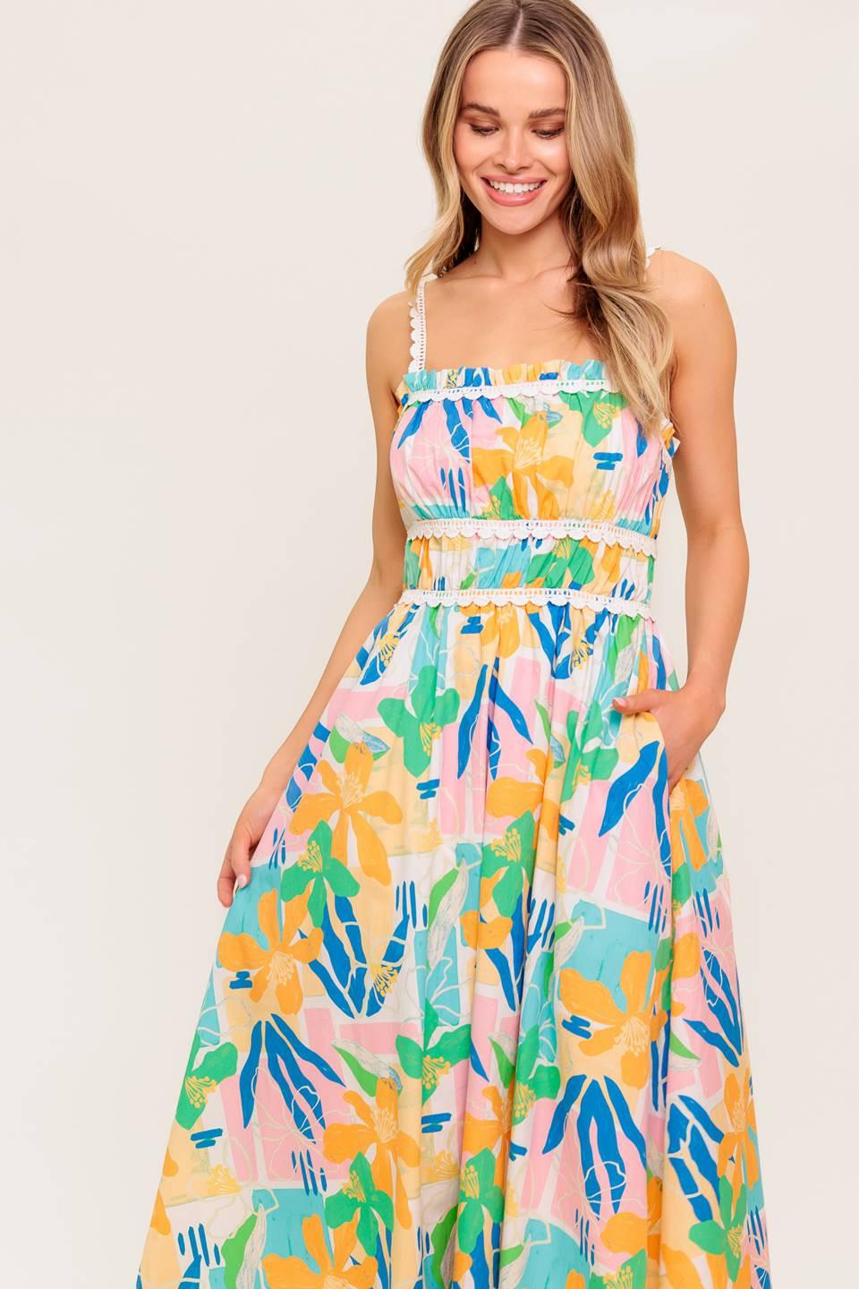 A printed woven midi dress featuring straight neckline, crochet lace strap and inset, shirred bust, full skirt and back zipper closure.