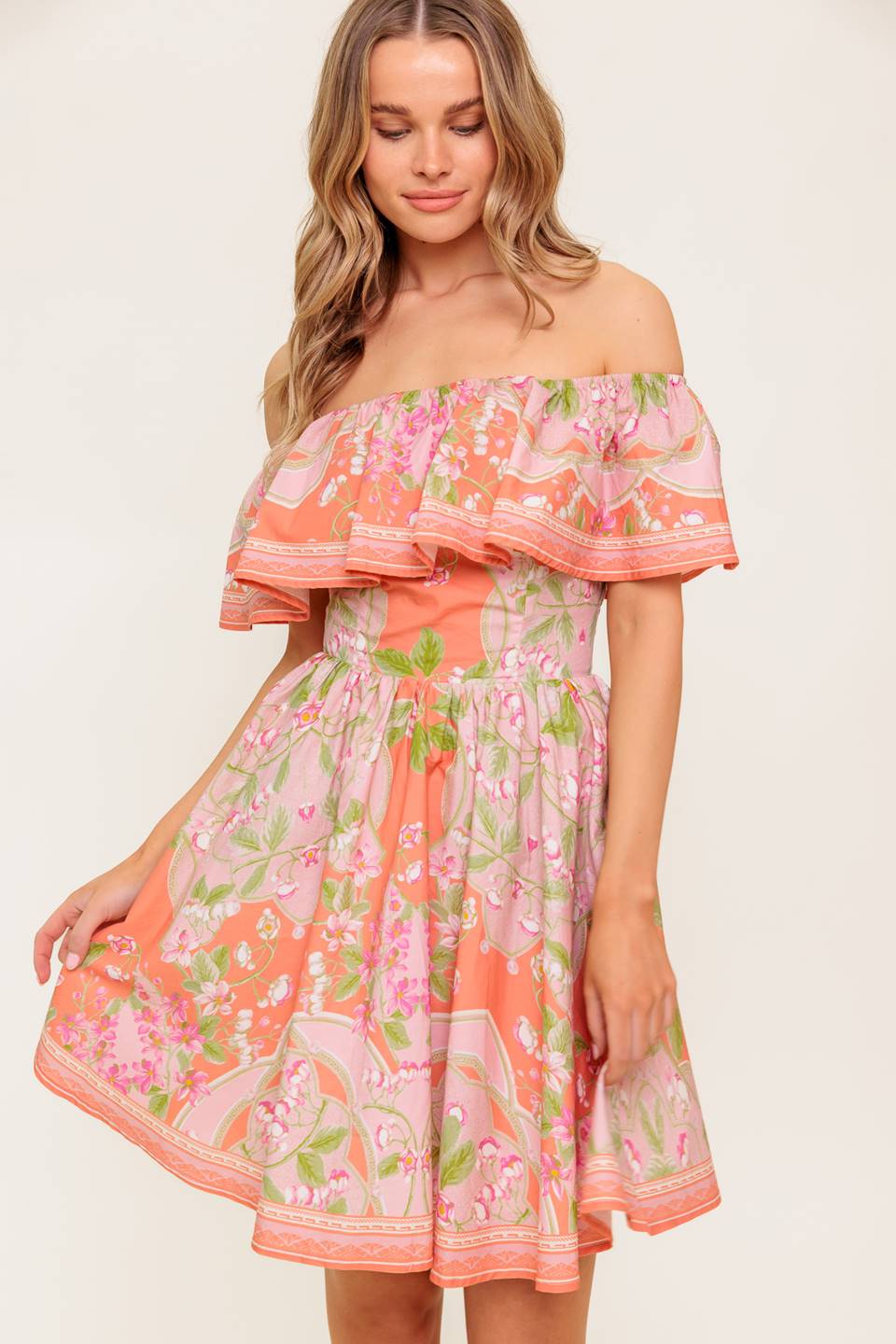 A printed woven mini dress featuring off shoulder neckline with flounce, full skirt and back zipper closure.