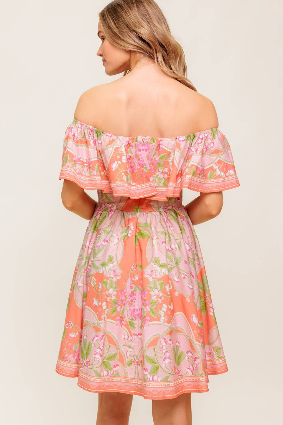 A printed woven mini dress featuring off shoulder neckline with flounce, full skirt and back zipper closure.