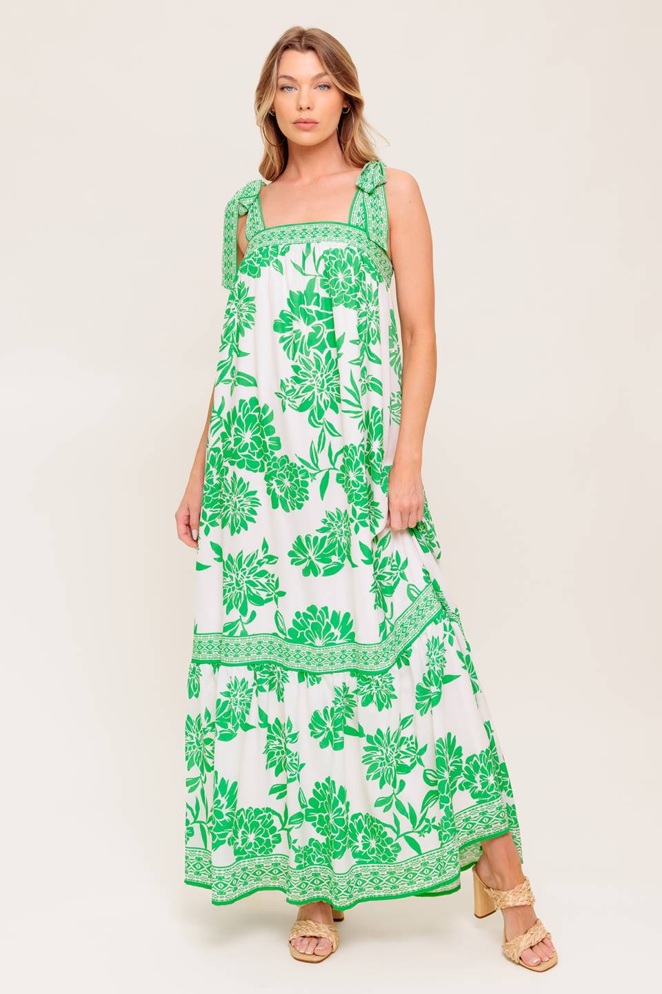 A printed woven maxi dress featuring straight neckline, shoulder tie and ruffled hemline